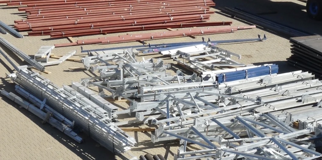 Steel structural components laid out in a yard, prepared for logistics handling